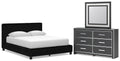 Black upholstered bed with two nightstands and wide dresser with framed mirror