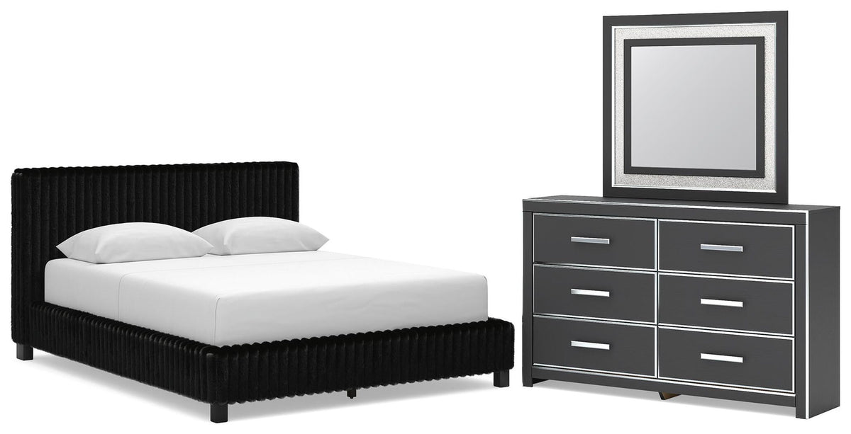 Black upholstered bed with two nightstands and wide dresser with framed mirror