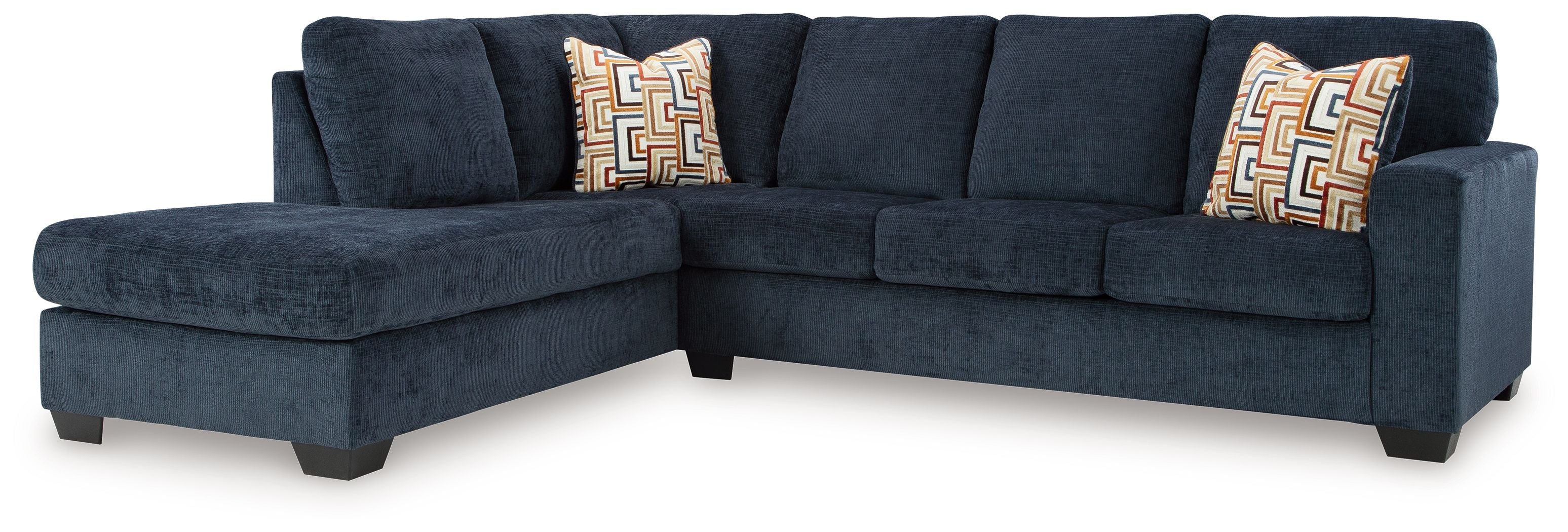 Dark blue sectional sofa with corner chaise and two geometric accent pillows