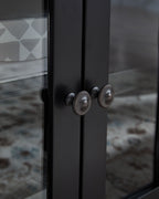 Black cabinet door with round metal knob handles