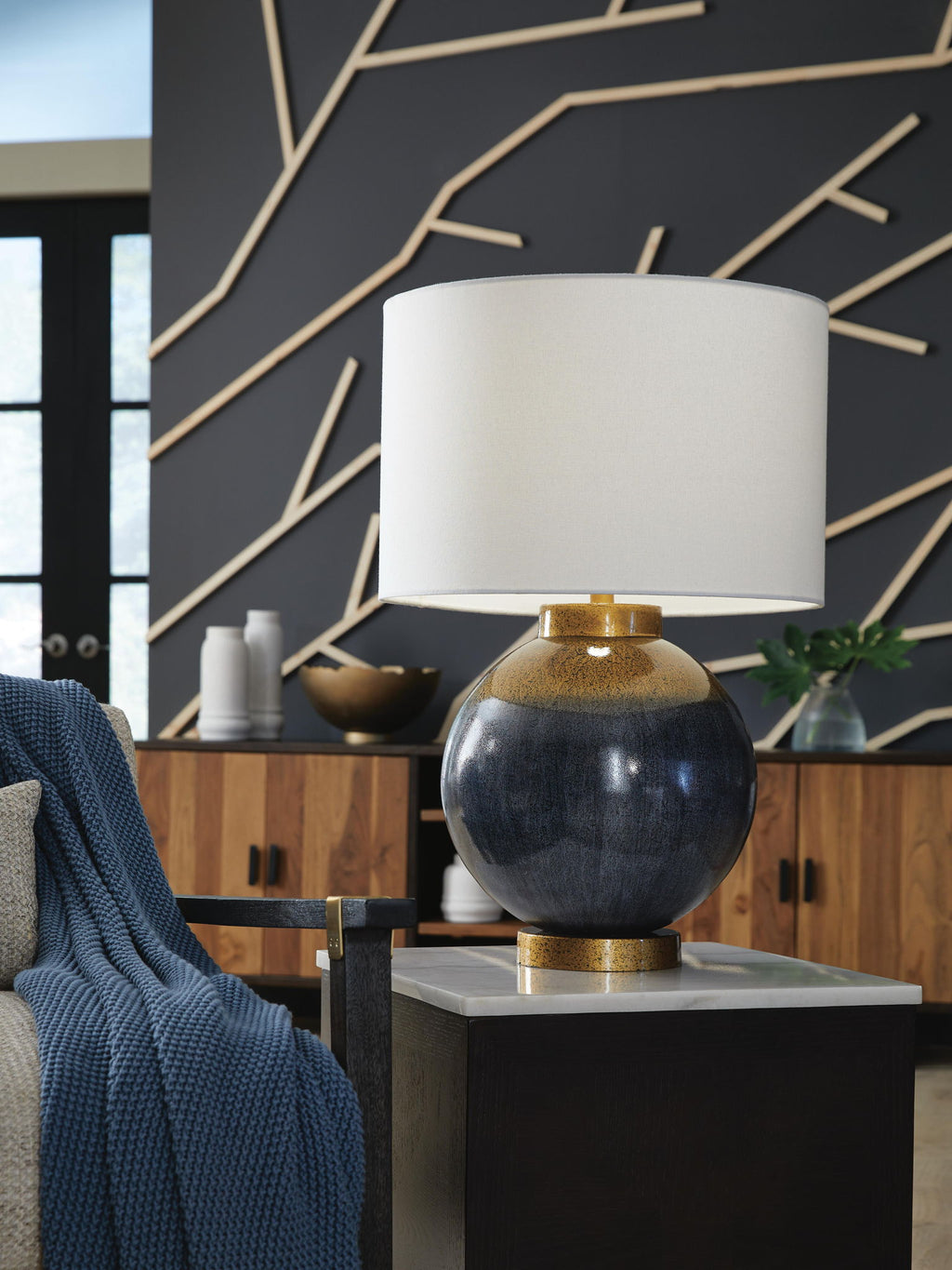 Blue and gold metal table lamp with white fabric shade