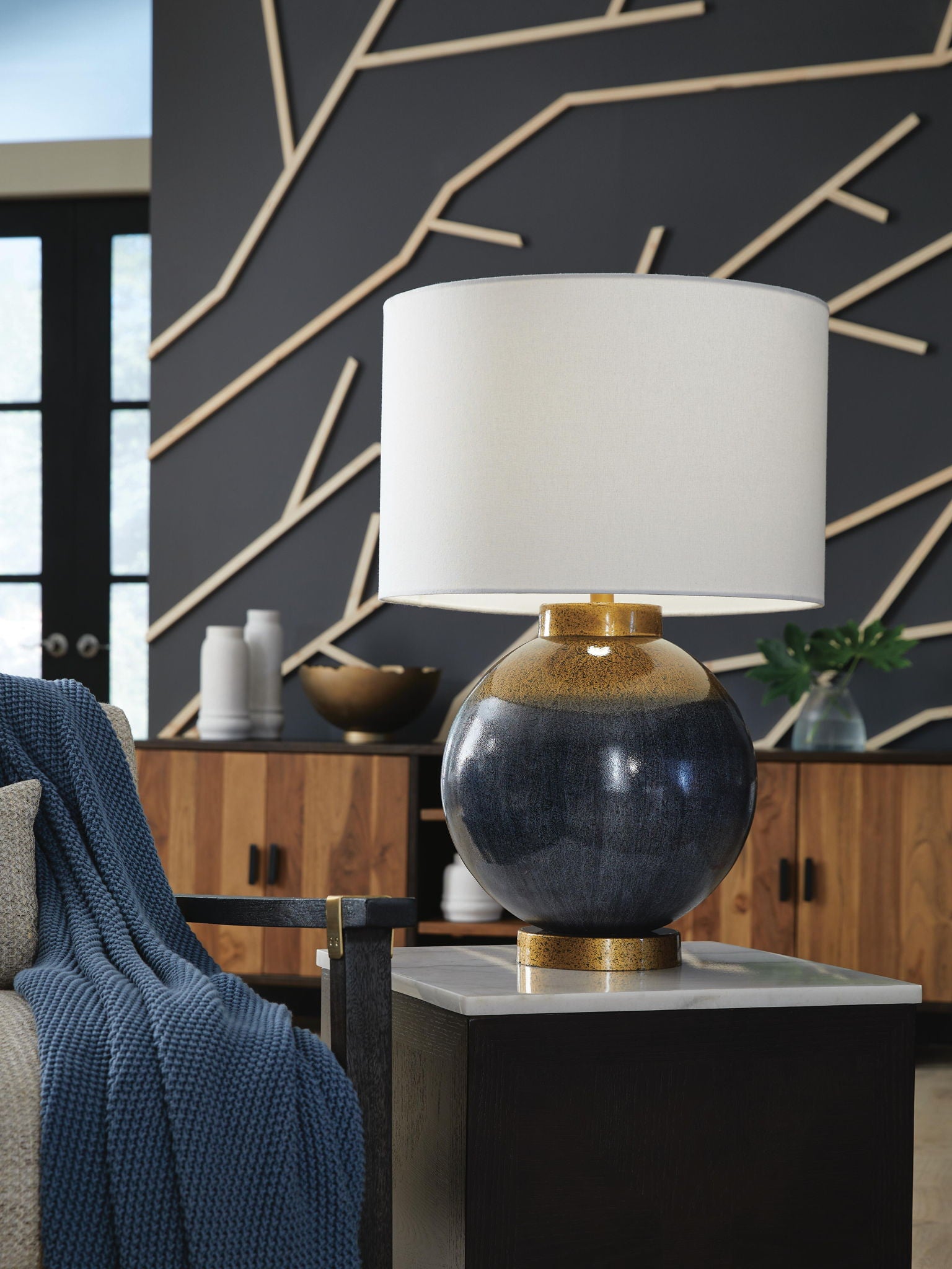 Blue and gold metal table lamp with white fabric shade