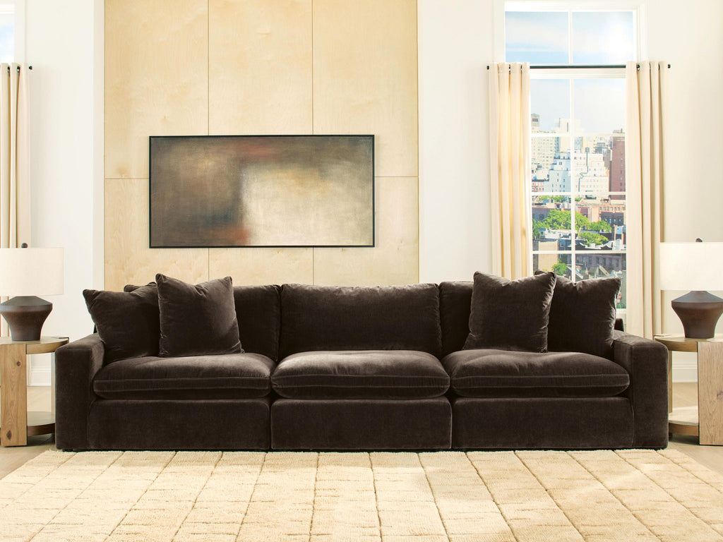 Dark brown 3-piece sectional sofa with four throw pillows and plush cushions