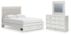 White upholstered panel bed with under-drawer storage and matching dresser with mirror