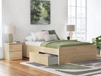 Light wood platform bed with drawers and slat base, shown with bedding