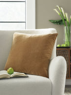 Jaxkins square pillow in light brown fabric on a sofa