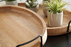 Wooden serving trays with black handles, close view of rims and stacked layers.