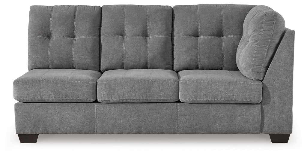 Gray fabric sofa with tufted back, three seat sections, and rounded right arm