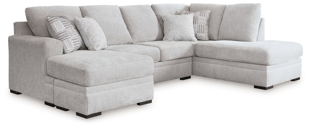 Gray fabric sectional sofa with chaise and tufted cushions, rounded arms and dark legs
