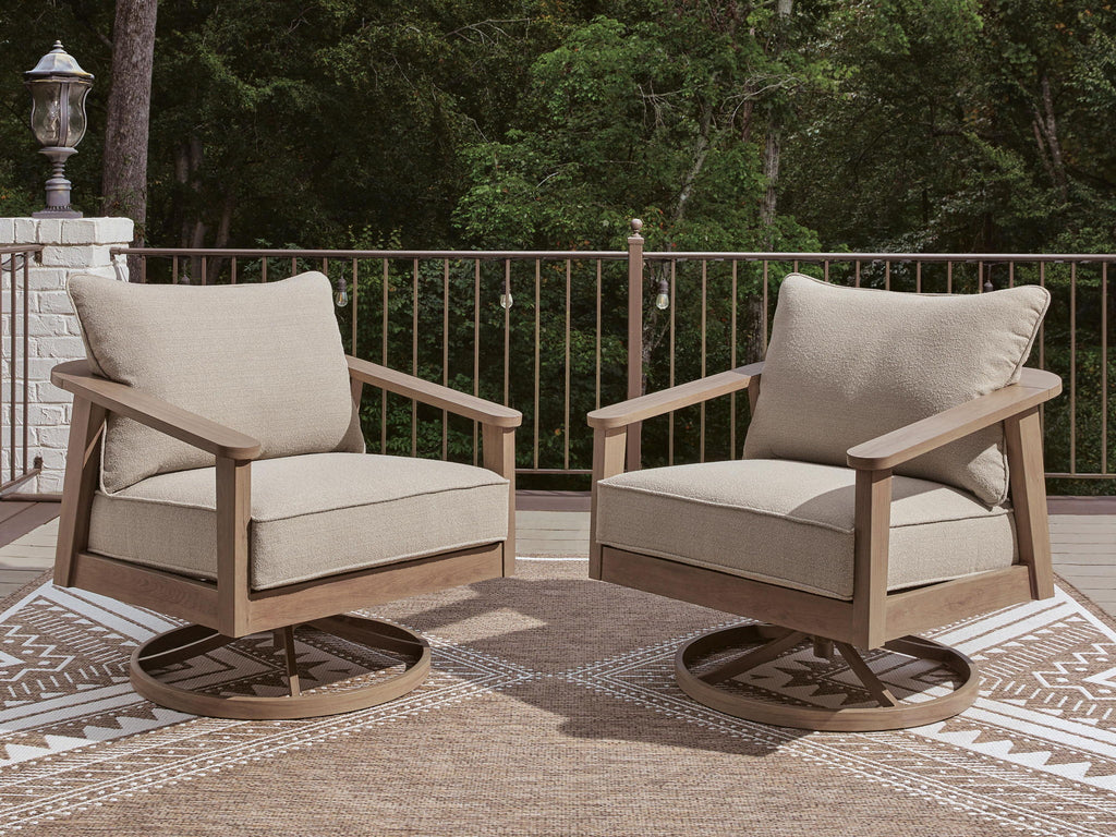 Pair of beige swivel lounge chairs with seat cushions and tall back cushions