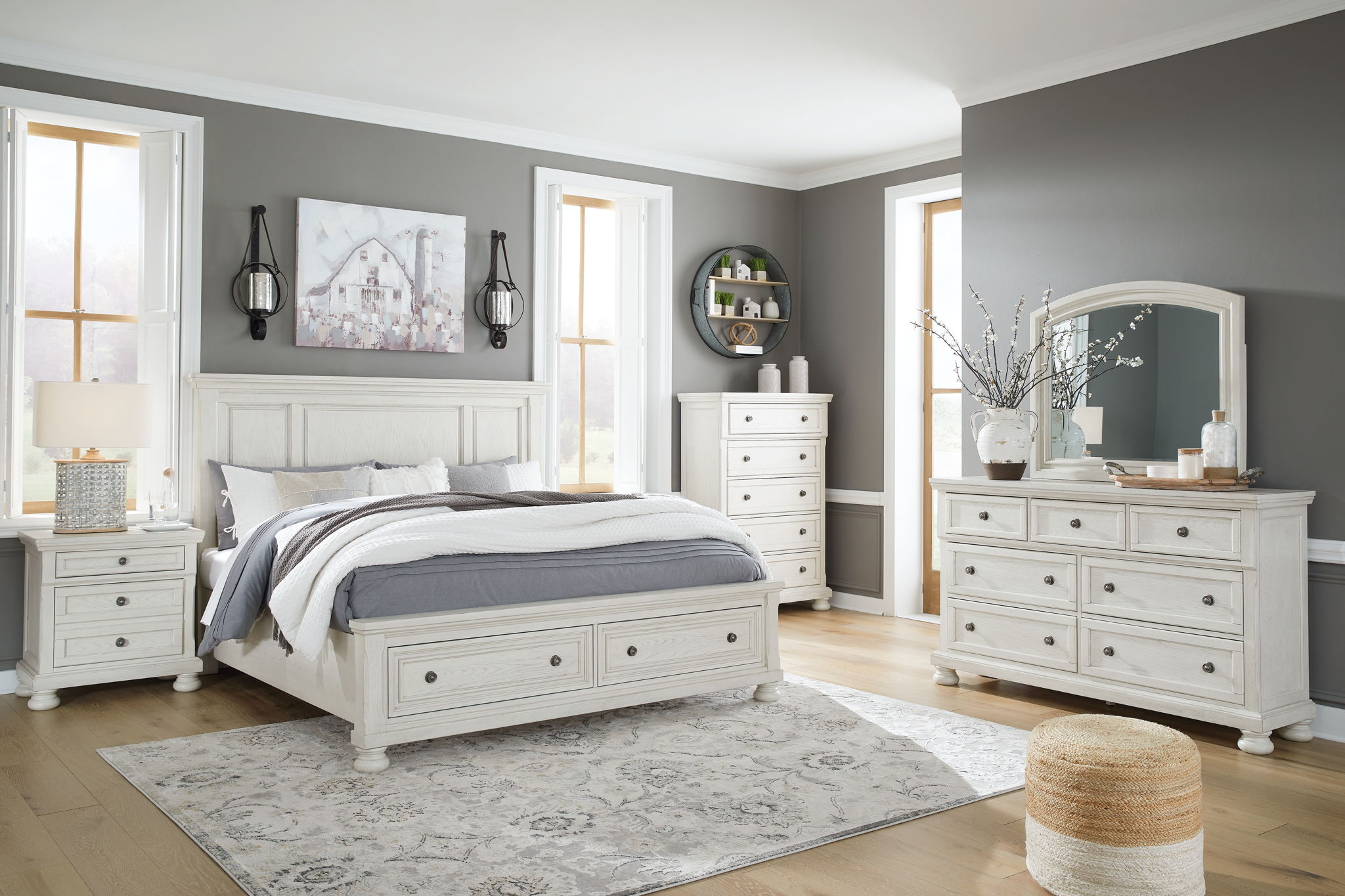 White bedroom set with panel bed, dresser, mirror, and matching storage drawers