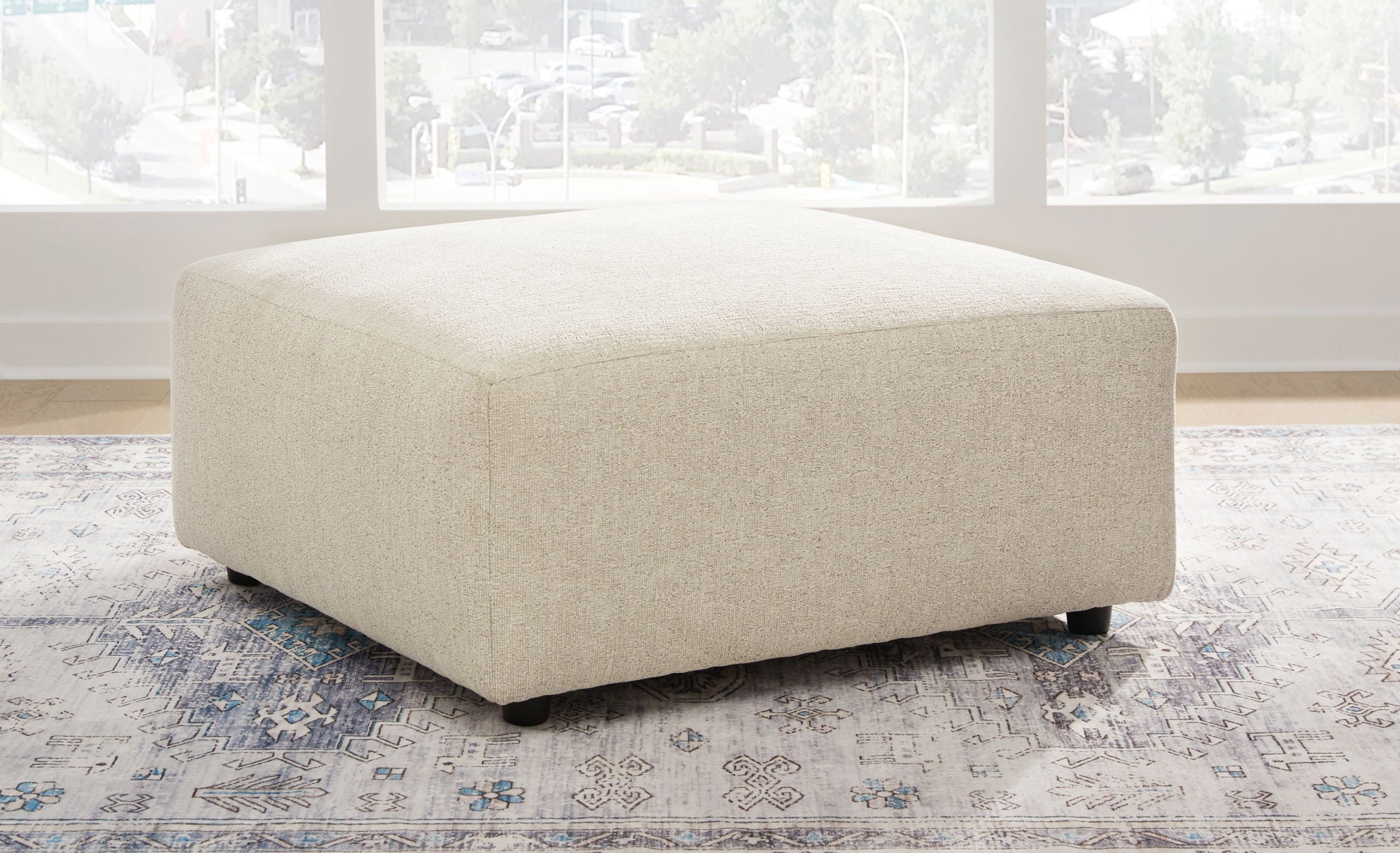 Pearl silver upholstered ottoman with square top and low legs