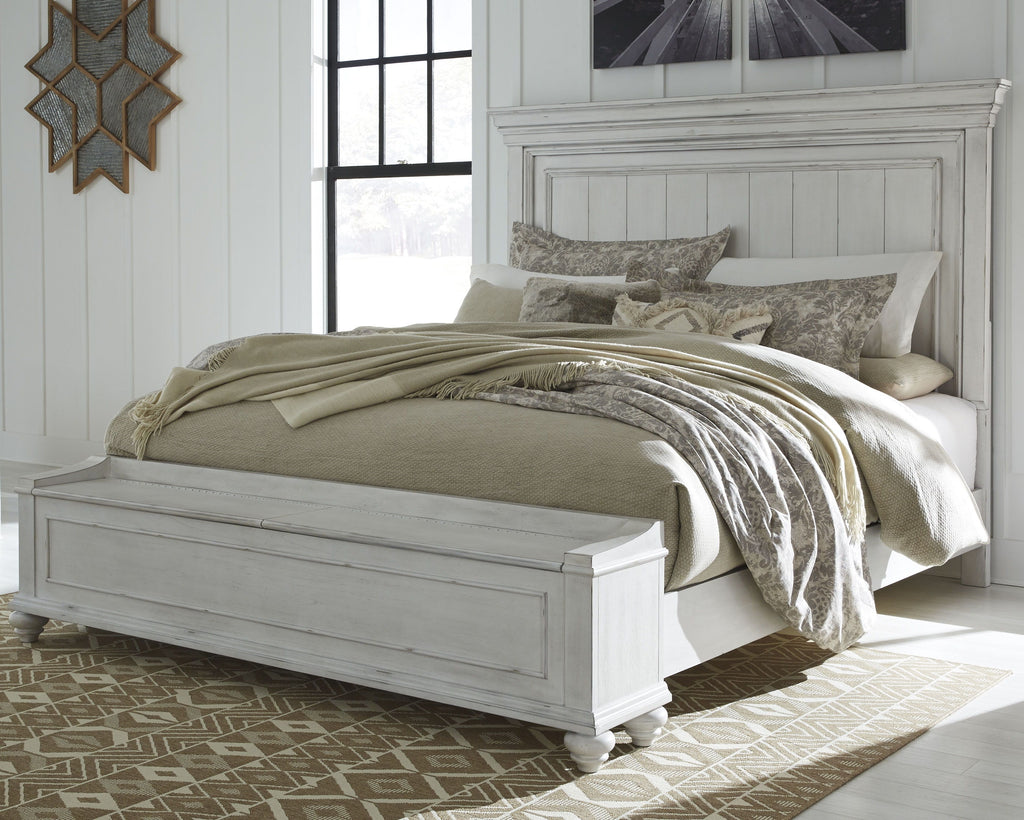 Panel bed with white headboard, beige bedding, and gray-patterned pillows