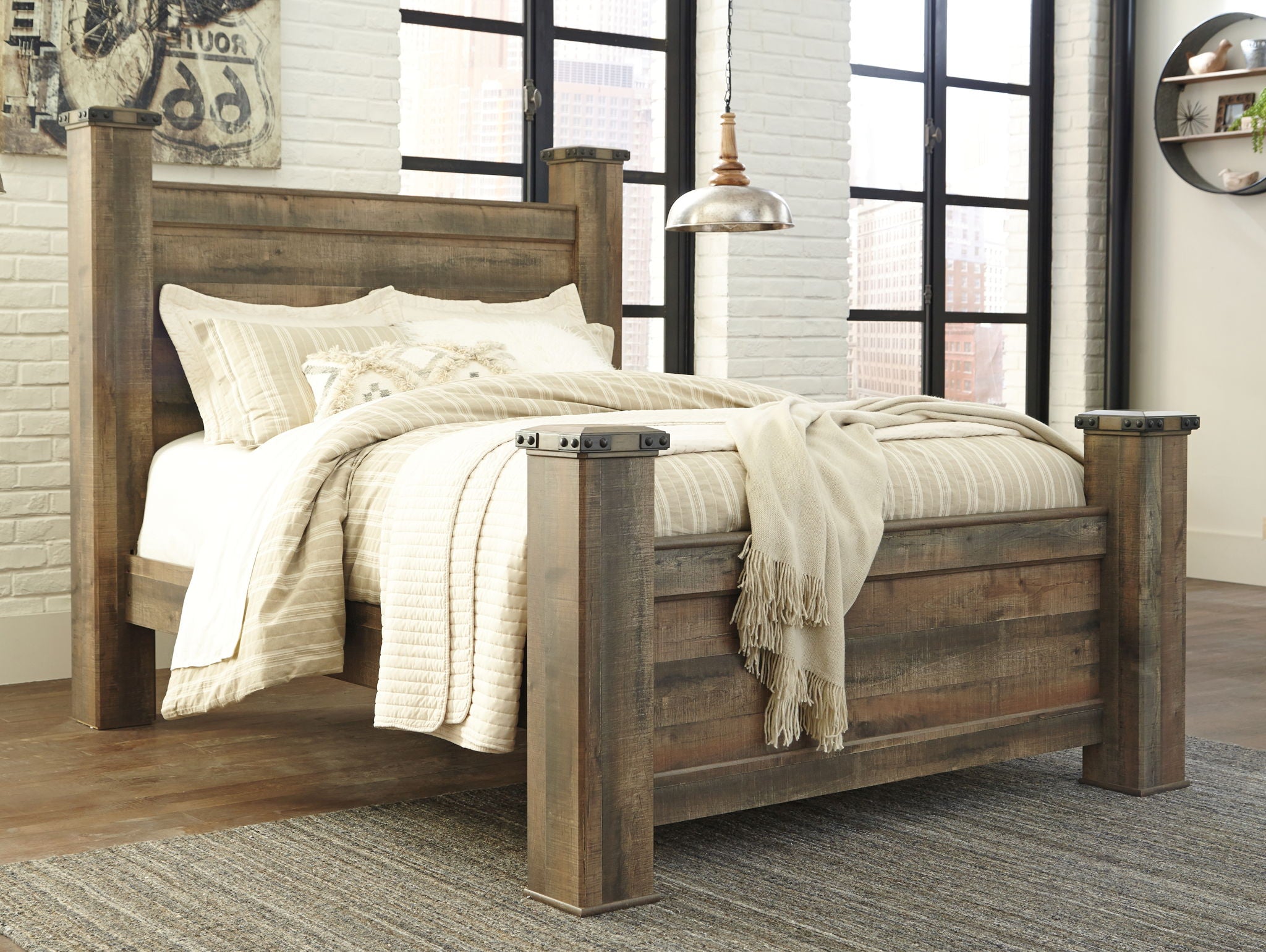 Dark brown poster bed with white bedding set and four corner posts