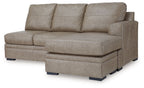 Beige fabric sofa chaise with wide chaise seat, three back cushions, and block legs