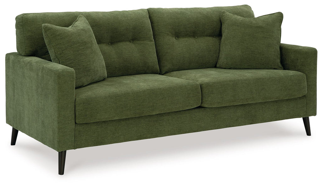Green upholstered sofa with three back cushions and two large throw pillows