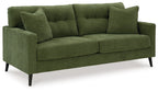 Green upholstered sofa with three back cushions and two large throw pillows