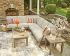 Beige outdoor sectional sofa corner with striped pillows and patterned accent cushions