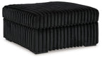 Oversized accent ottoman in dark onyx, ribbed fabric, rounded tufted top