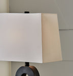 Black table lamp base and white square shade close-up