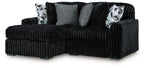 Sectional sofa with chaise, black corded fabric and gray throw cushions