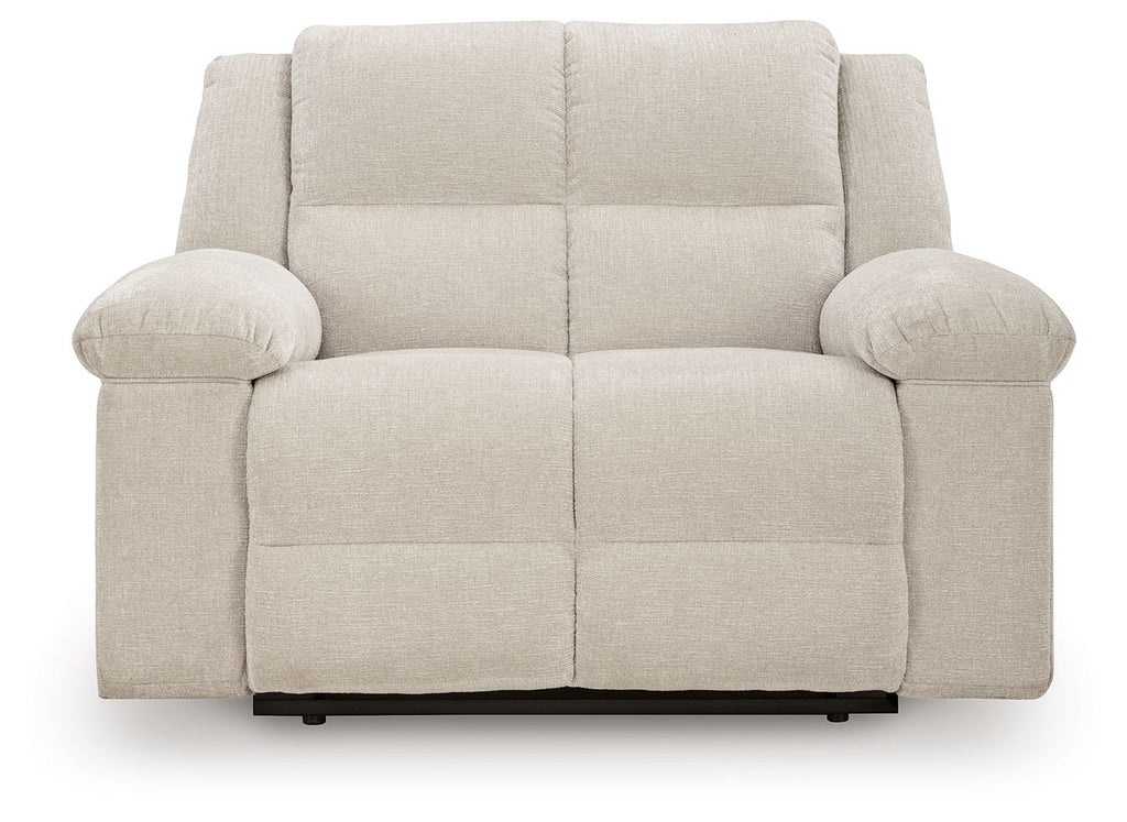 Recliner chair in light beige with rounded arms, cushioned back, and center seam