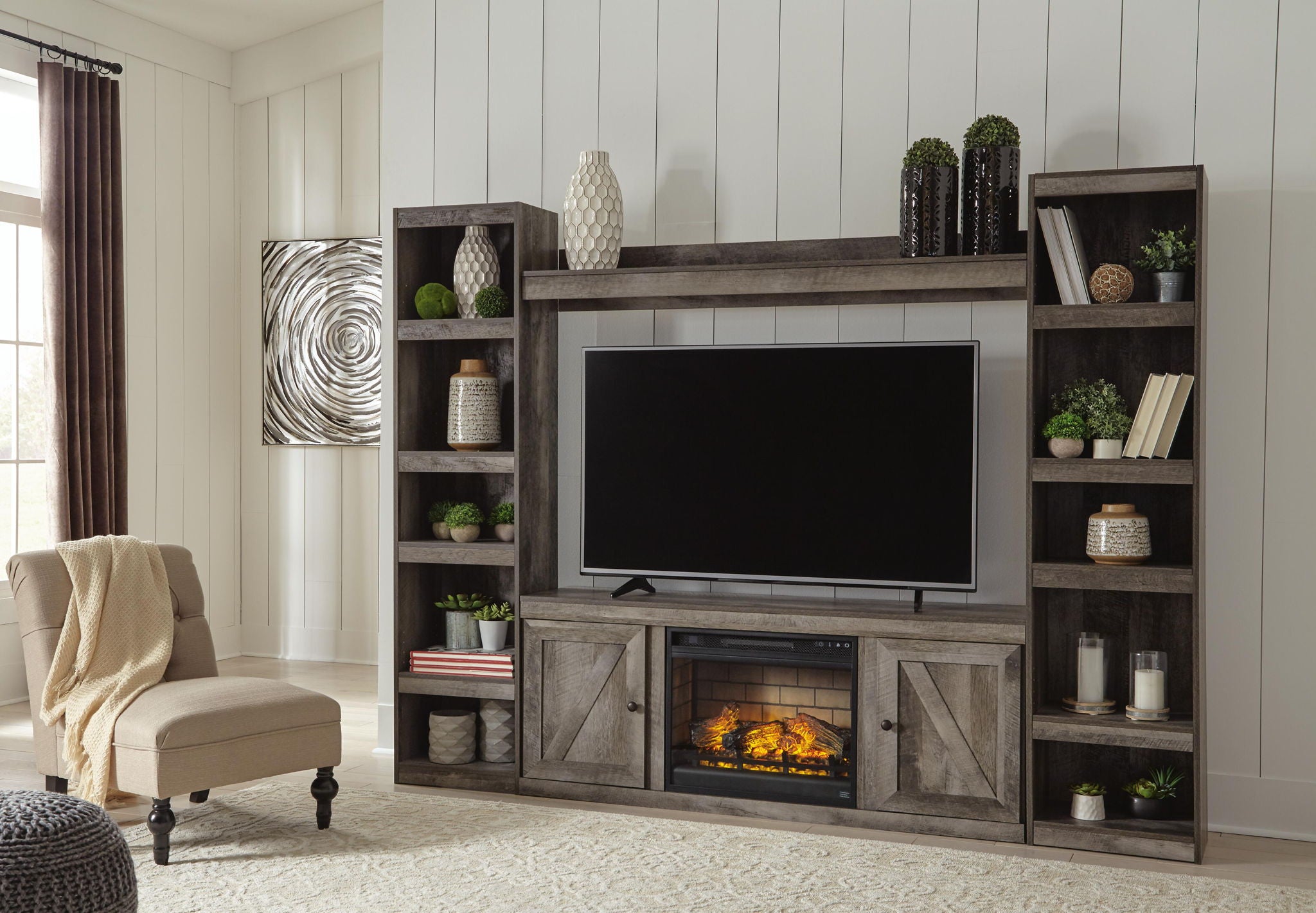 Gray media console with large TV opening, lower faux firebox, and paneled cabinet doors