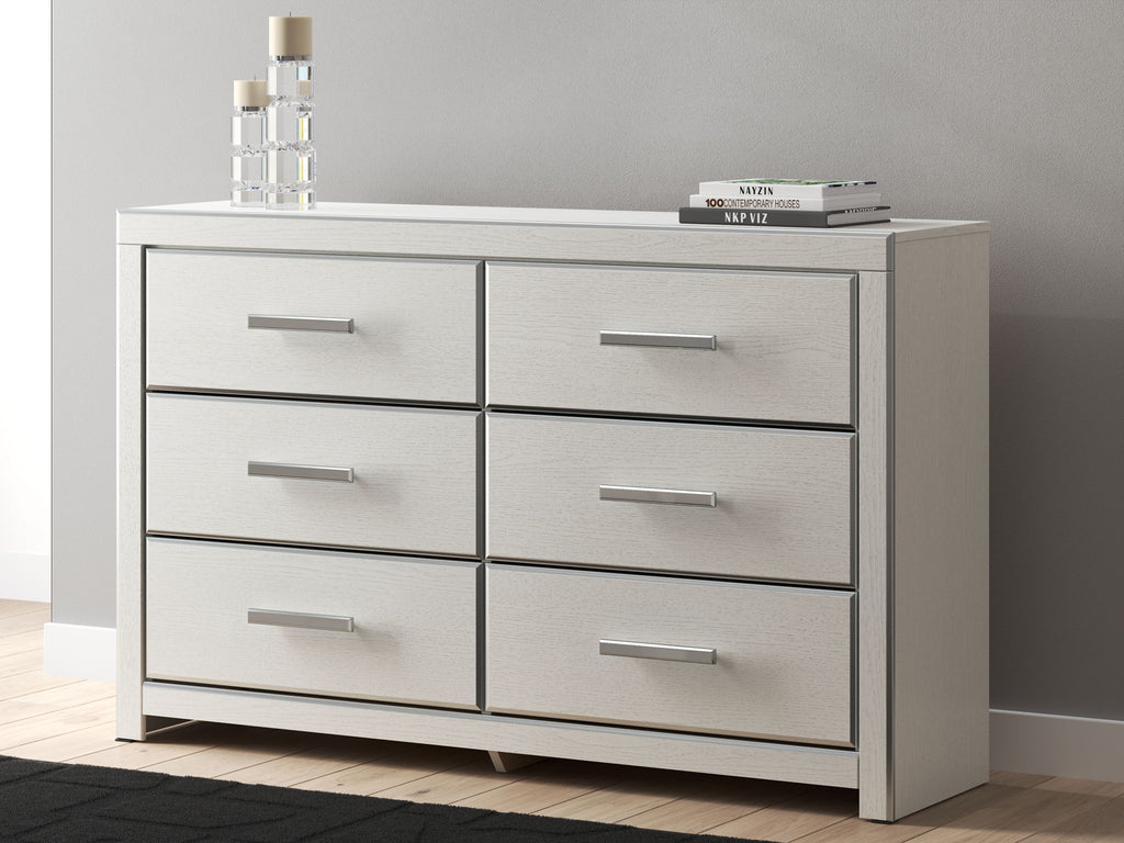 Six-drawer dresser in light gray/white with six drawers and silver bar handles.