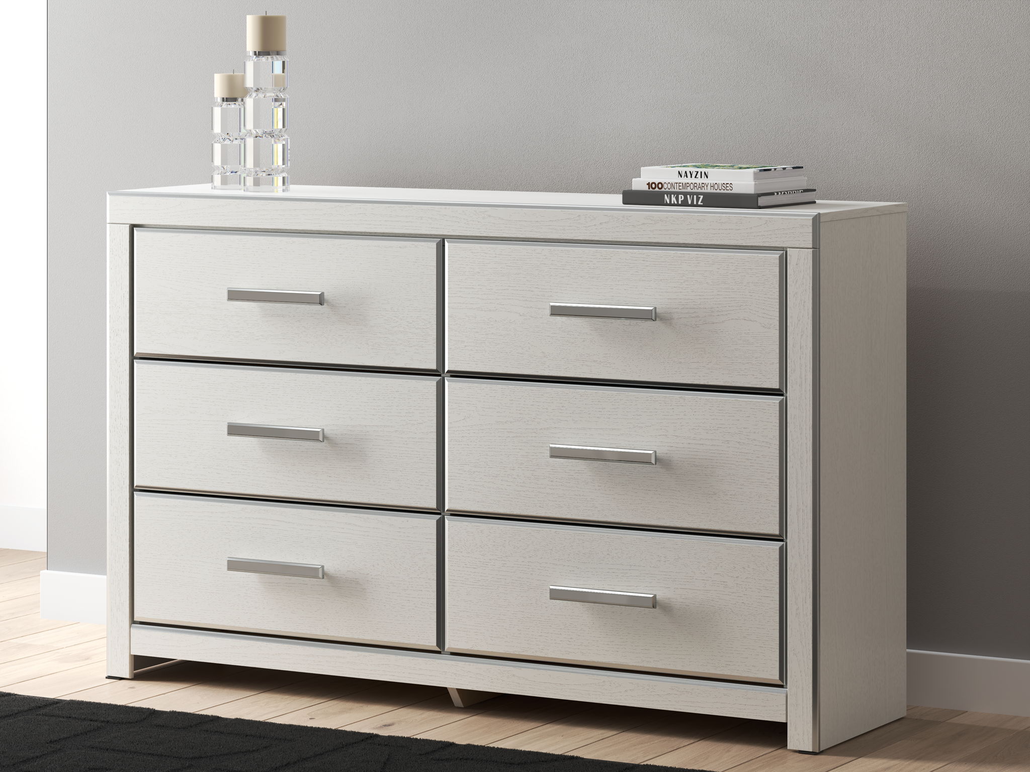 Six-drawer dresser in light gray/white with six drawers and silver bar handles.
