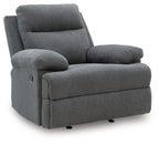Dark gray reclining armchair with padded headrest, rounded arms, and low black base