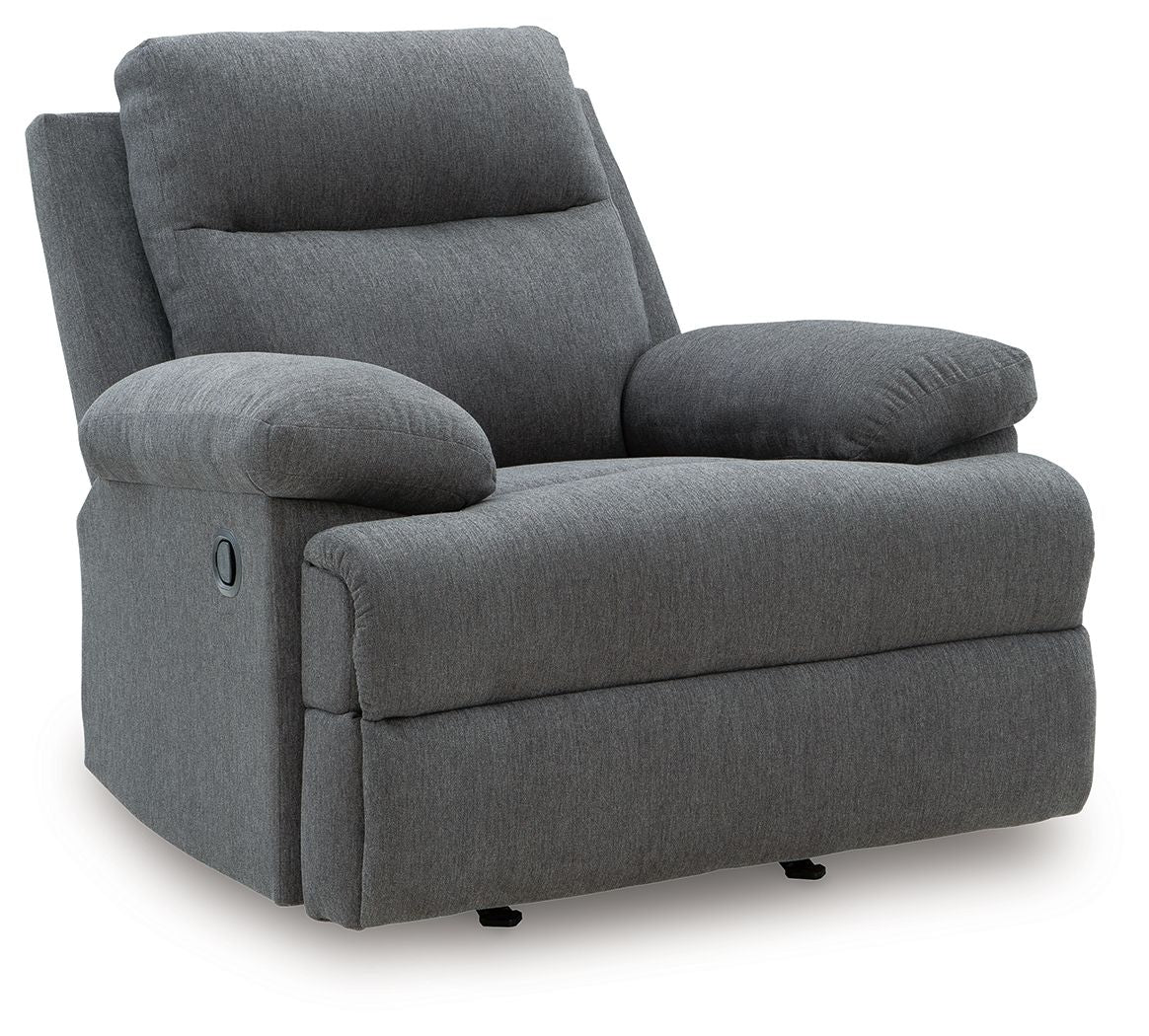 Dark gray reclining armchair with padded headrest, rounded arms, and low black base