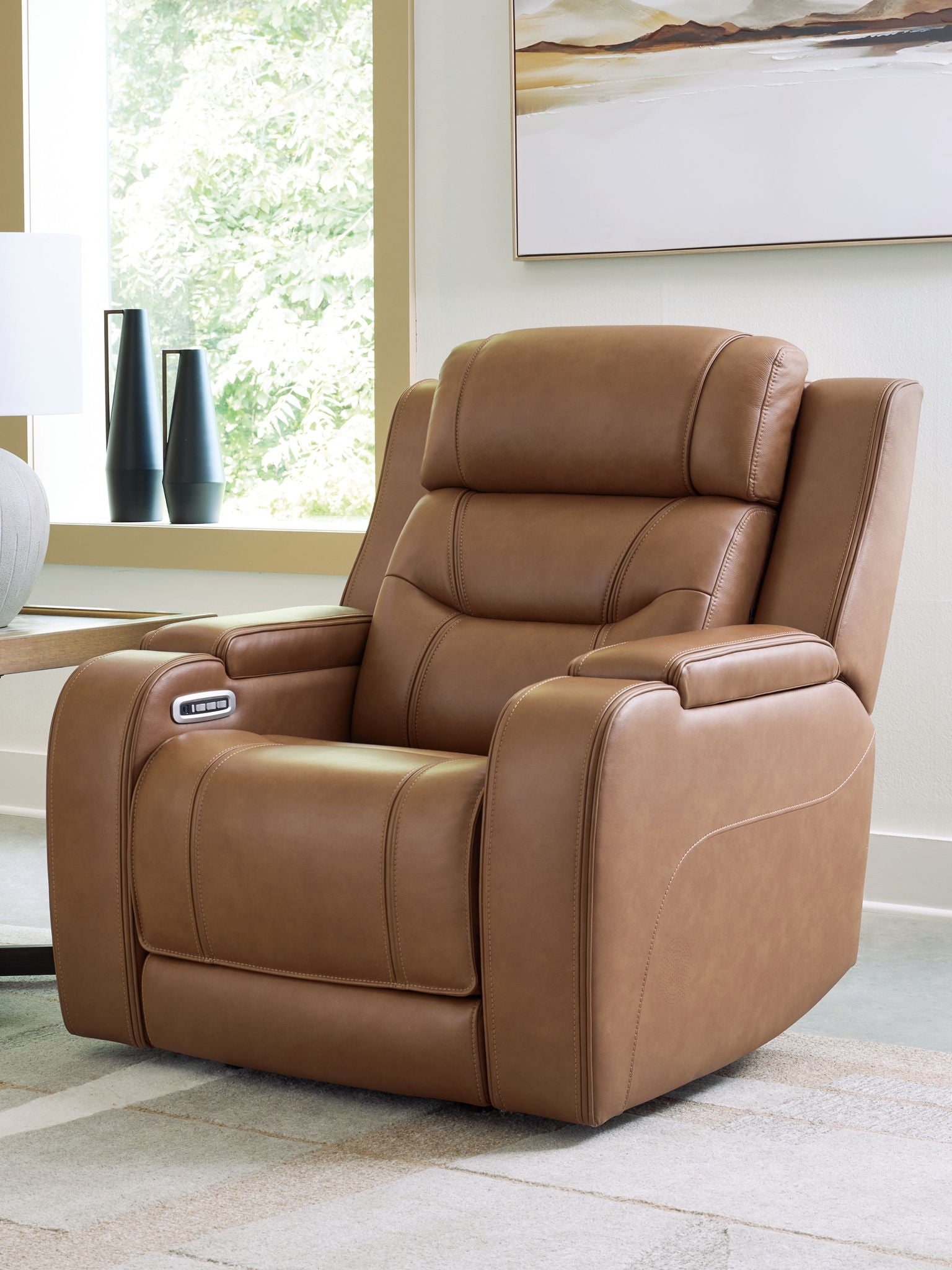 Brown power recliner with recline controls on the arm and cushioned pull-out footrest