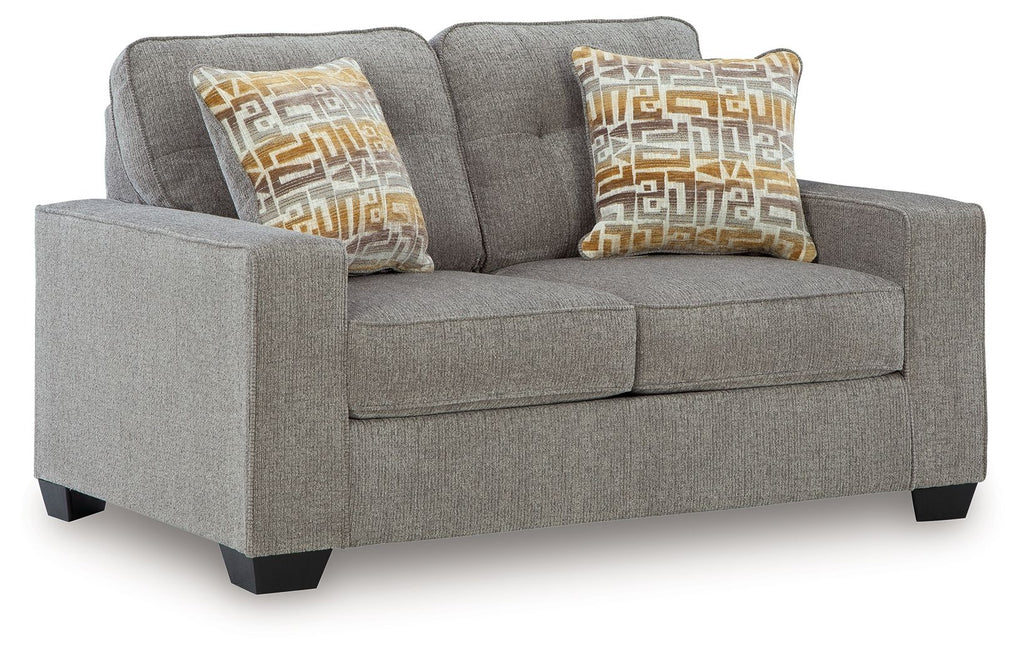 Gray upholstered loveseat with two seat cushions and patterned accent pillows