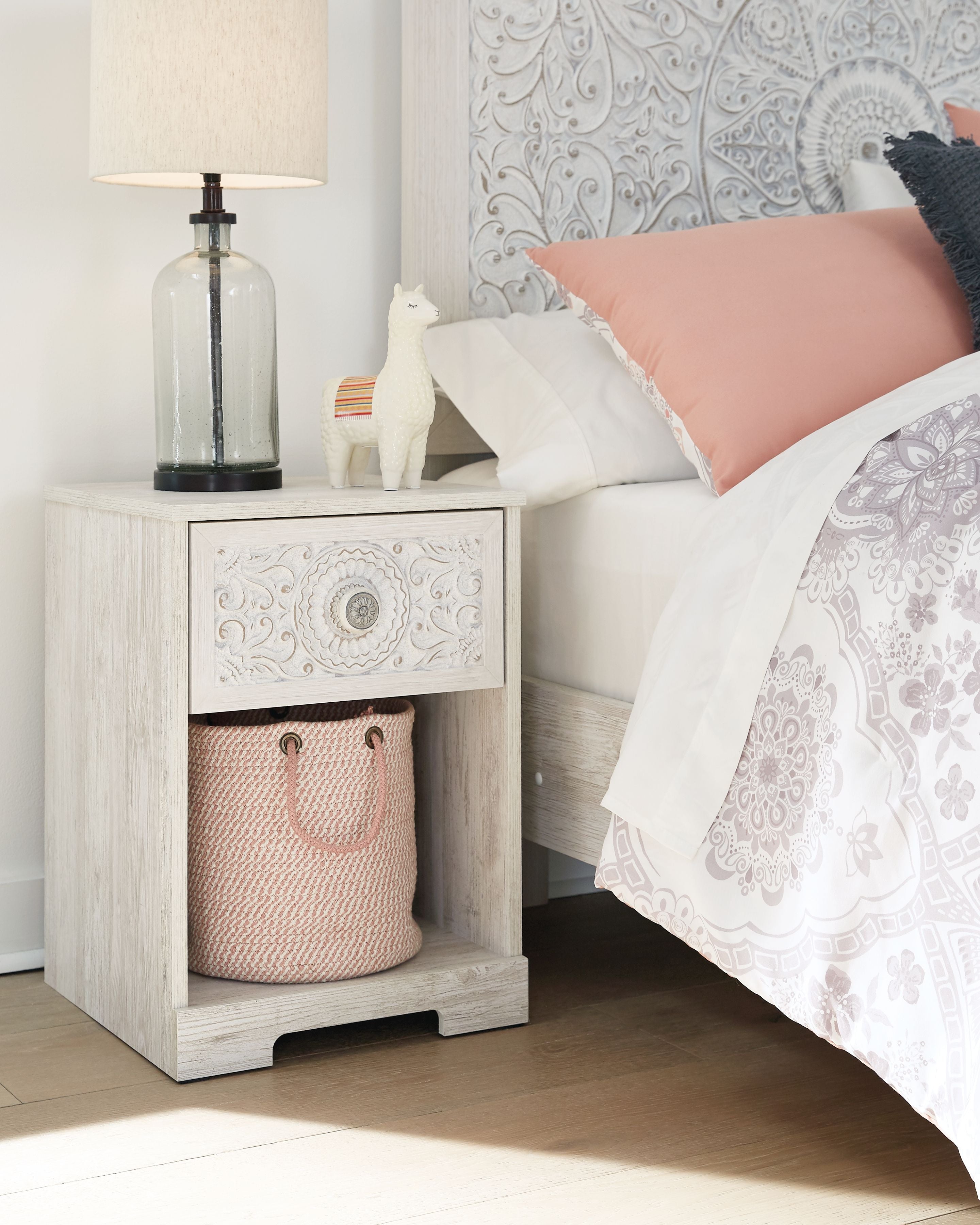 Paxberry whitewash night stand with cubby basket and carved drawer front