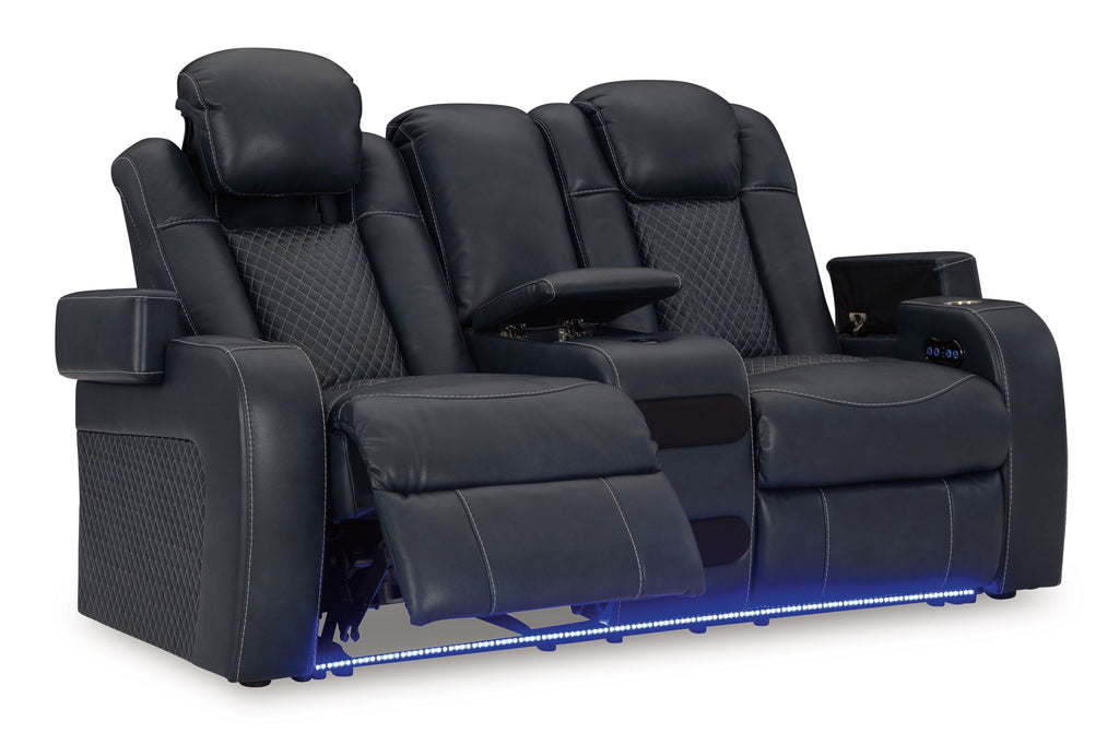 Dark blue power reclining loveseat with center console and adjustable headrest panels