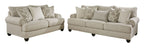 Two light gray upholstered seating pieces with patterned accent pillows