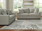 Gray upholstered sofa and loveseat set with square arms and decorative pillows