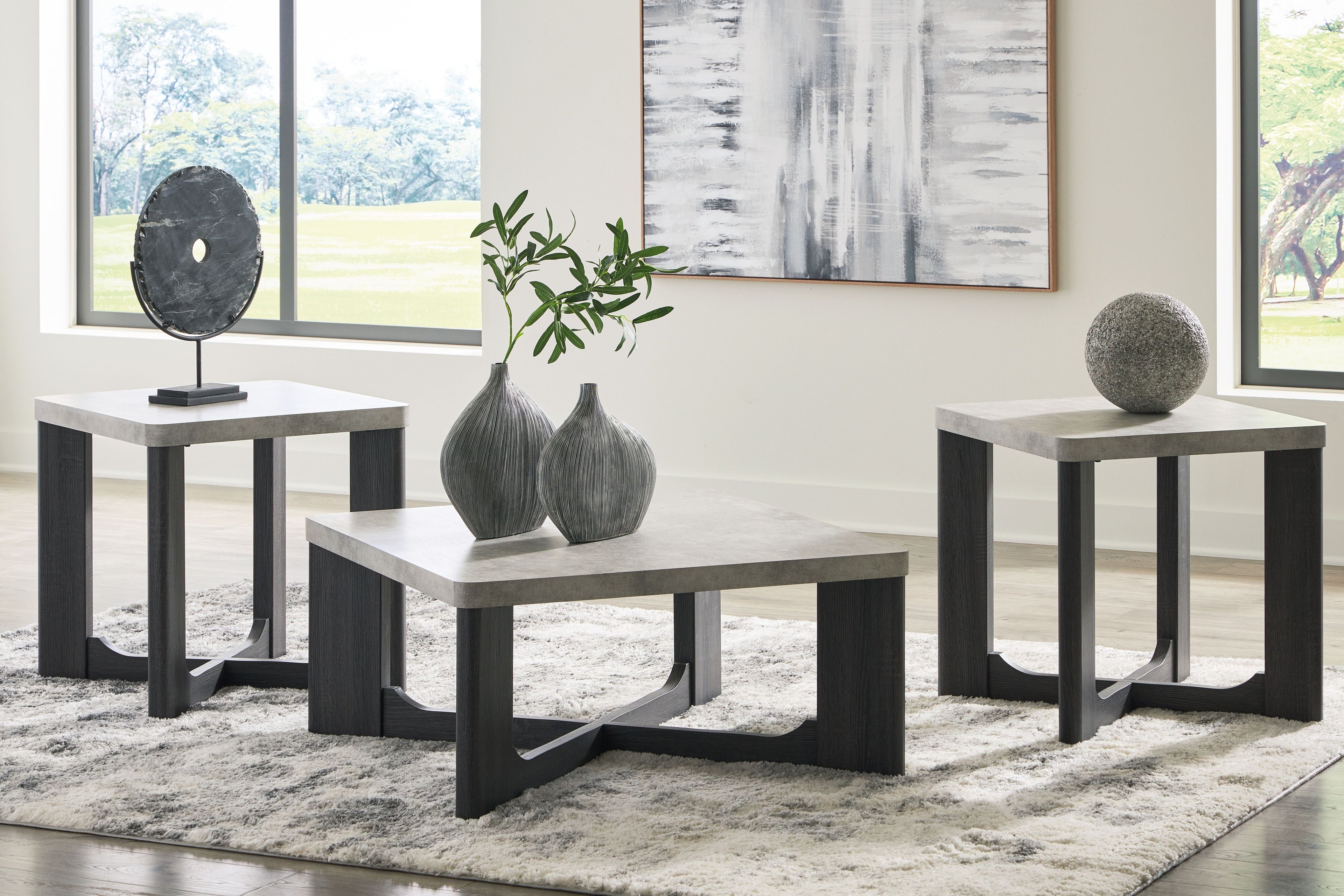Occasional table set with two-tone gray tops and dark frames, three-table view