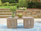Beige round cocktail table with slatted sides, outdoors