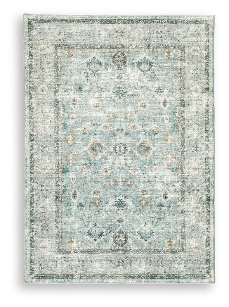 Ladstoney rug with faded blue floral motifs on a light ground and ornate corner details