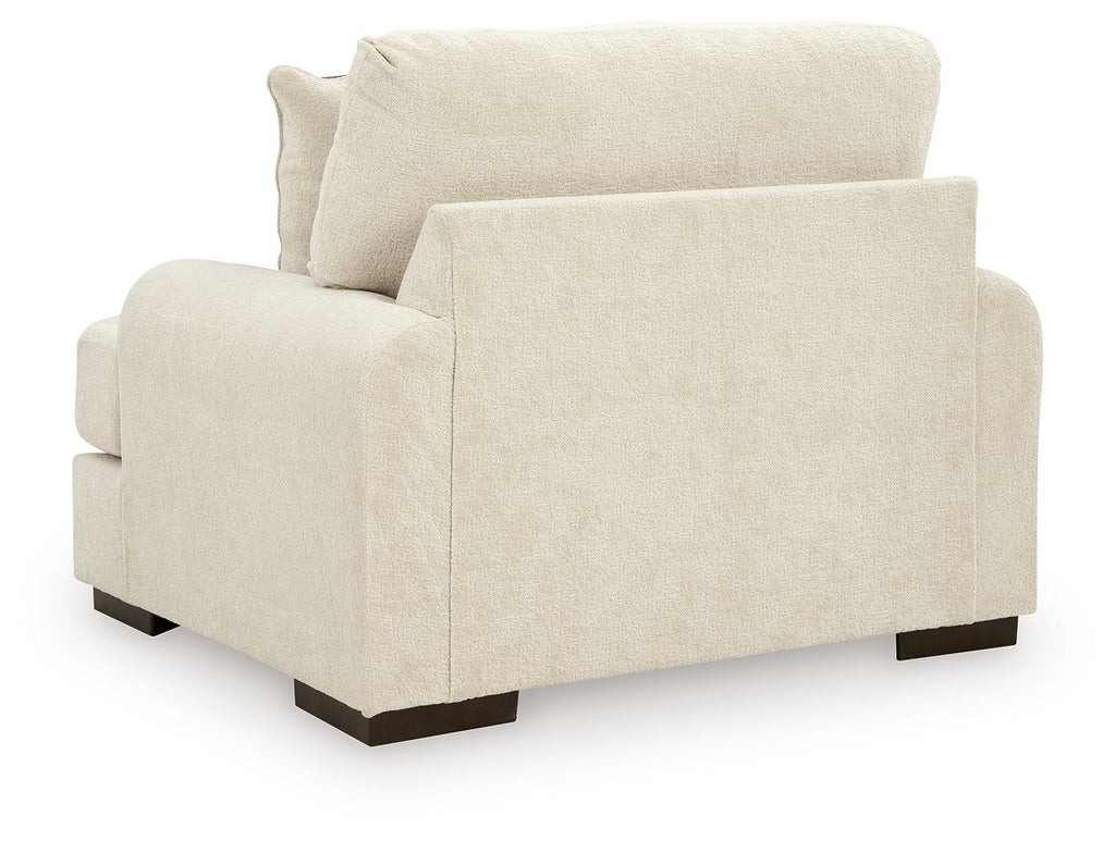 Beige armchair with wide arms and dark legs, shown from front three-quarter angle