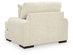 Beige armchair with wide arms and dark legs, shown from front three-quarter angle