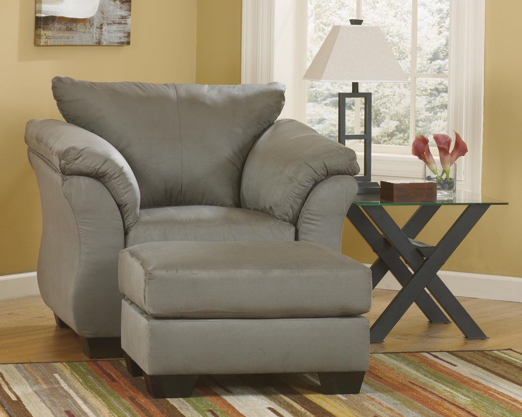 Dark gray arm chair with padded arms, plush seat, and rolled back cushion