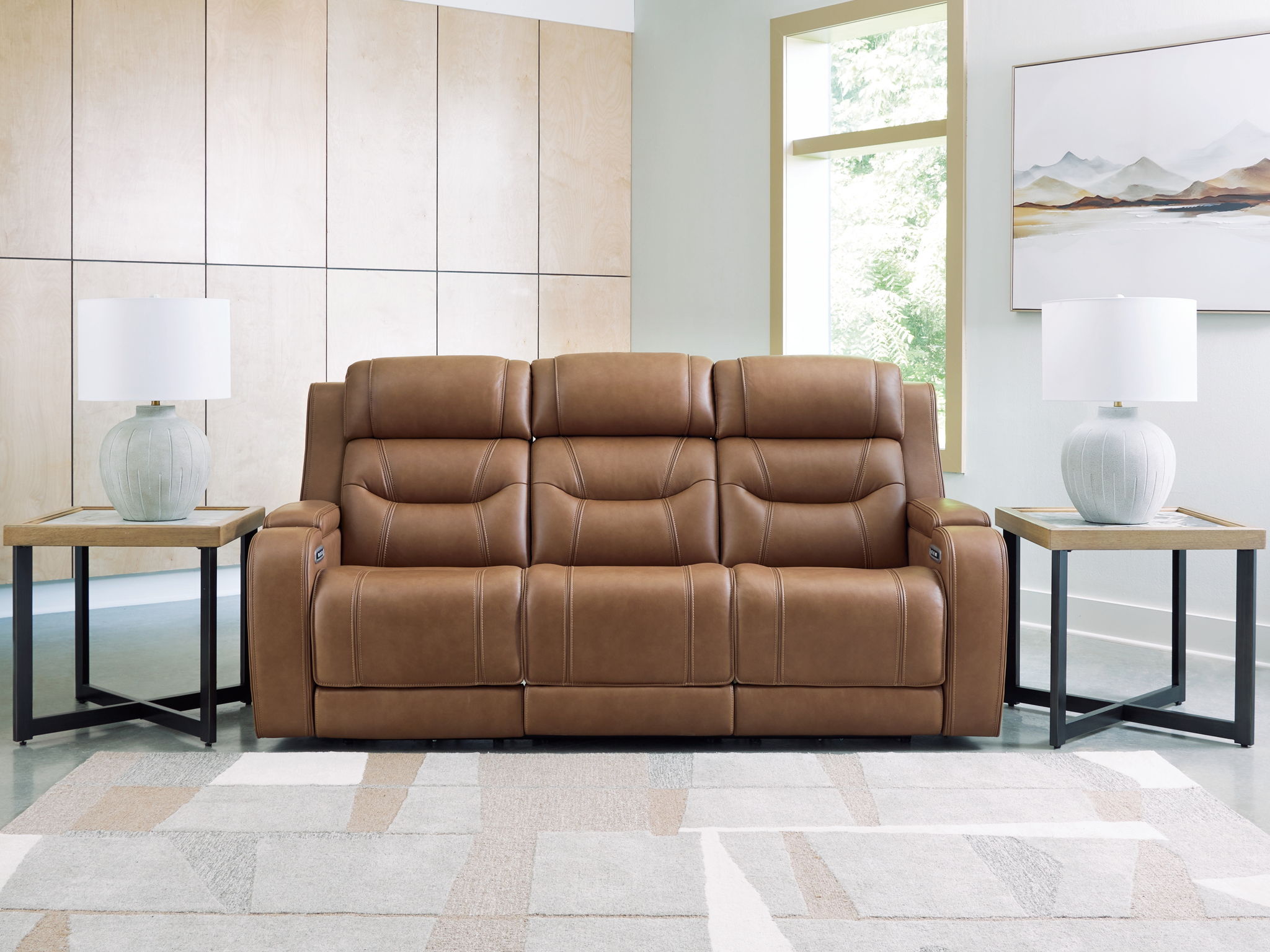 Dark brown power reclining sofa with padded arms, tufted cushions, and center console