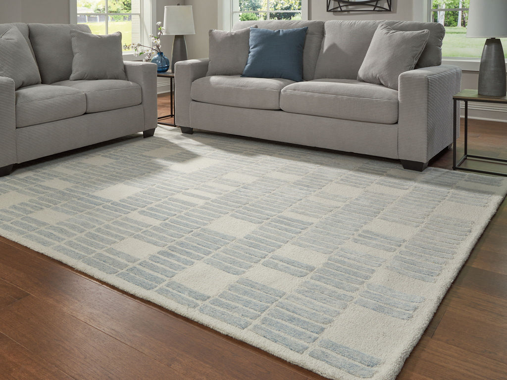 Light blue area rug with repeating grid pattern, rectangular shape on floor