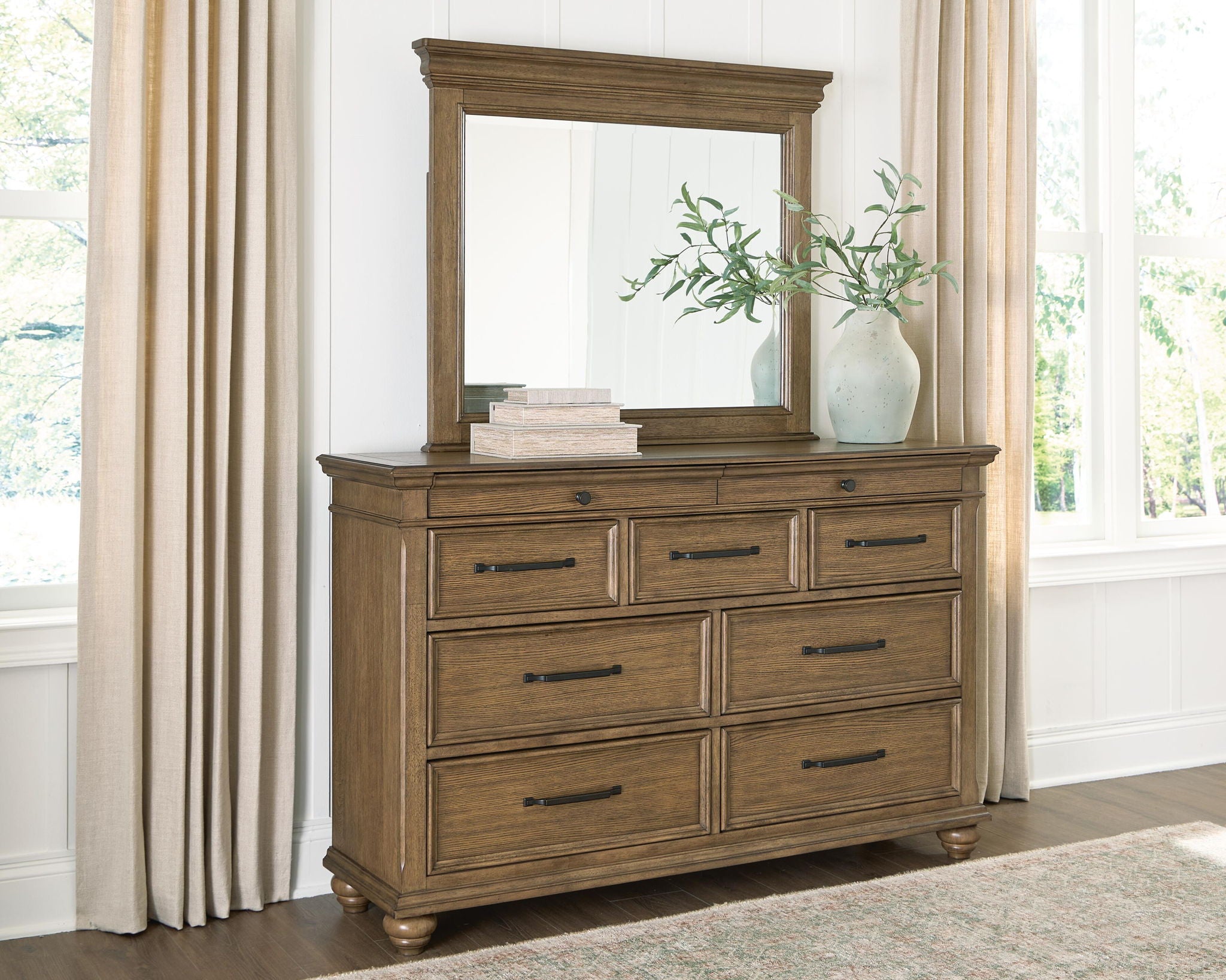 Dark brown dresser with attached mirror, eight drawer fronts, and metal bar pulls on legs.