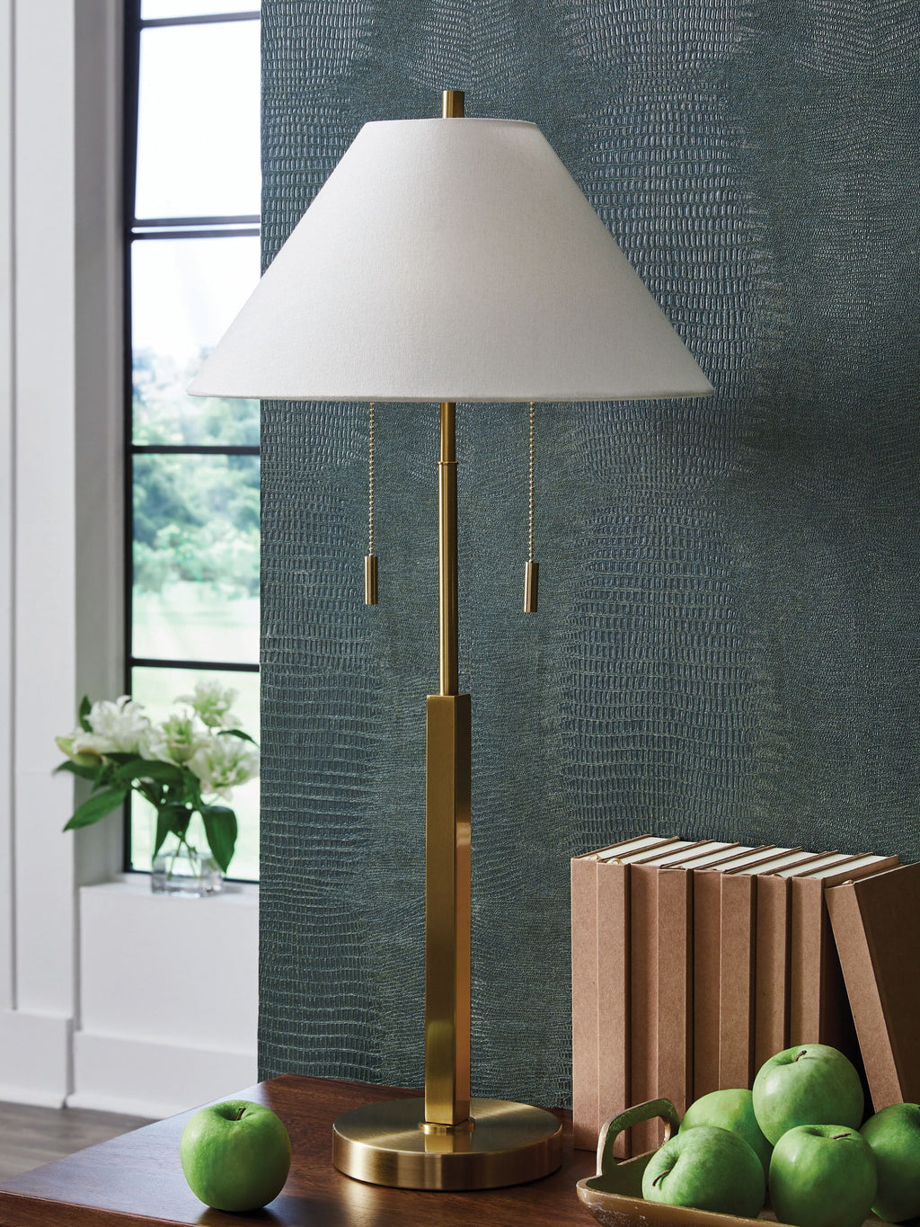 Gold floor lamp with white shade, round base, and hanging pull cords.