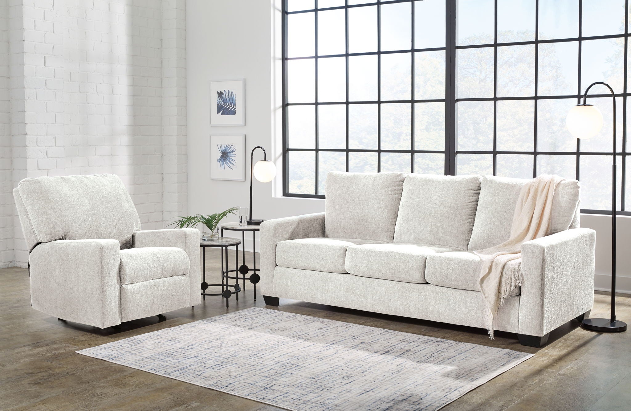 Cream fabric sofa with matching armchair, throw draped over sofa arm