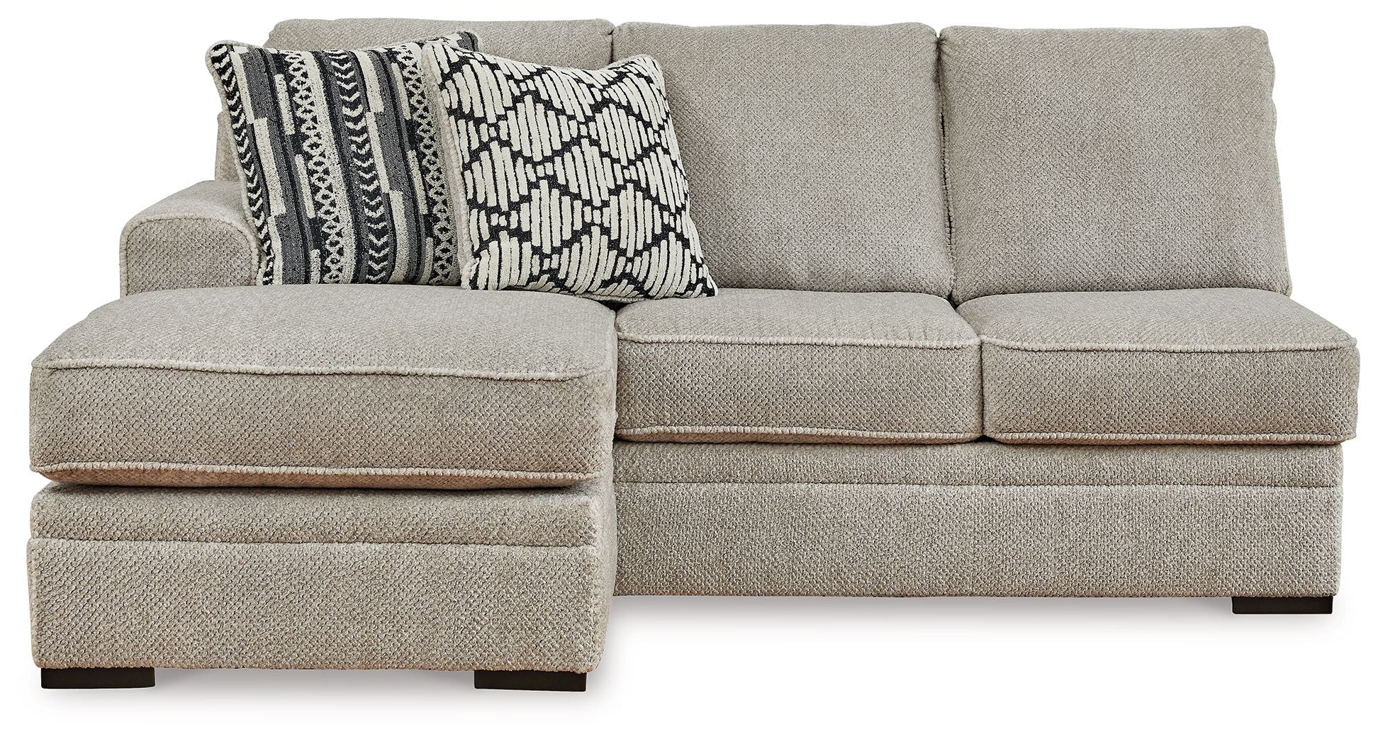 Light gray sofa chaise with square arms and two-tone geometric patterned throw pillows