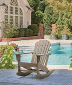 Light brown wooden rocking chair with slatted seat and back, curved runners